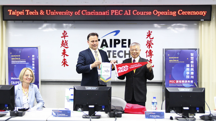 Gift exchange between Taipei Tech President Wang and UC CEAS Dean Orkwis
